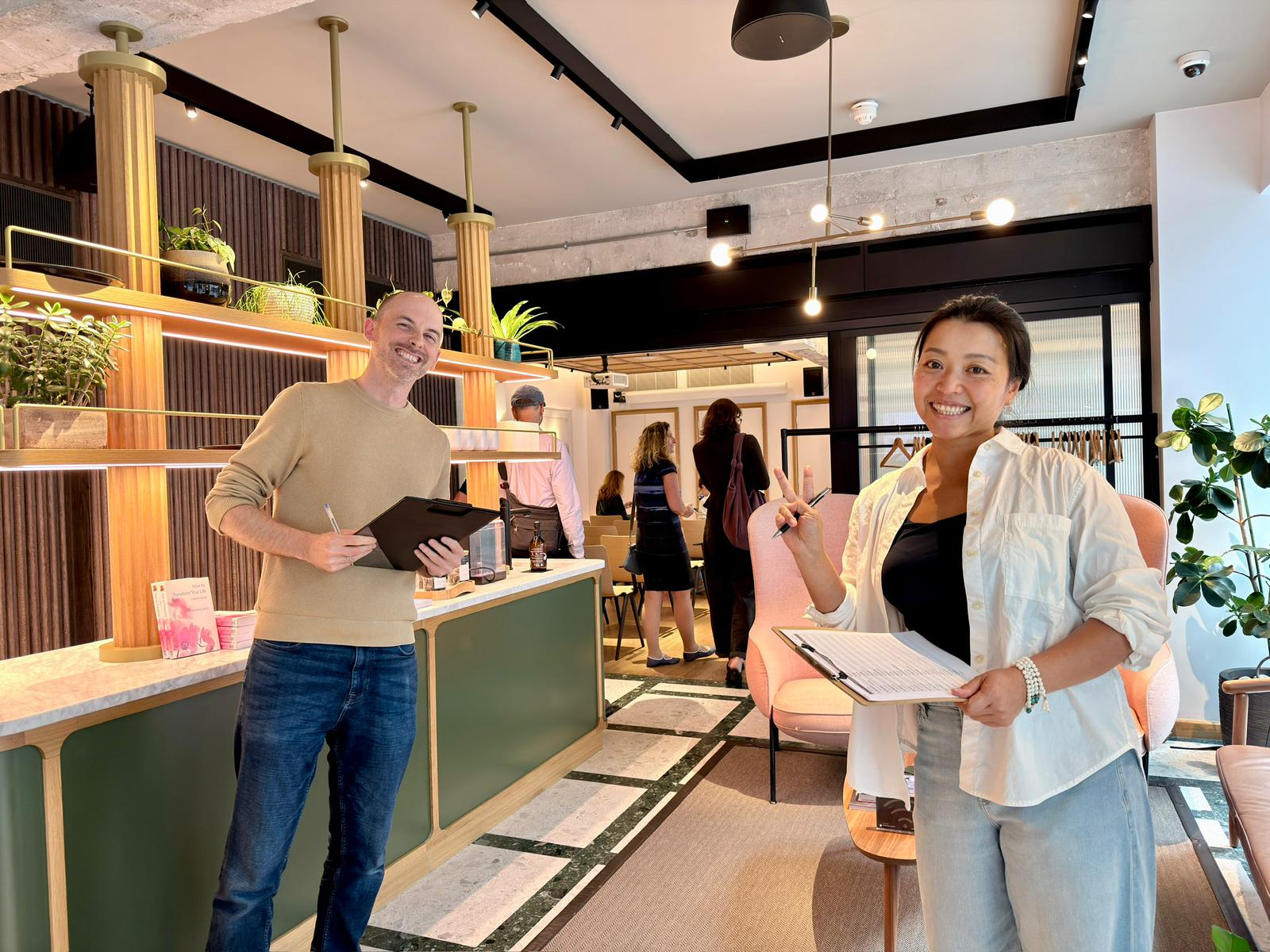 Two volunteers welcoming visitors at the desk before the Tuesday meditation class in Piccadilly
