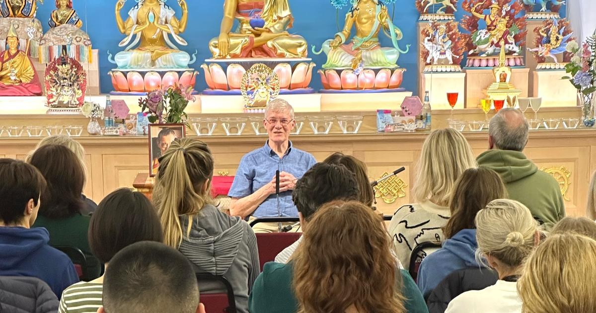 Kadam John McBretney teaching a class in the Heruka KMC meditation hall, with students seated before the shrine